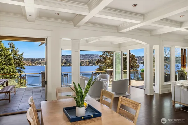 a living room with furniture potted plant floor to ceiling window and potted plant
