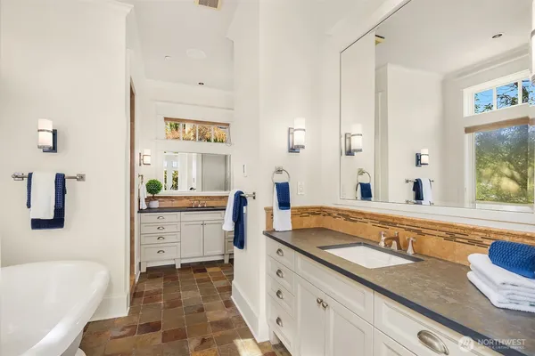 a spacious bathroom with a granite countertop sink and a large mirror