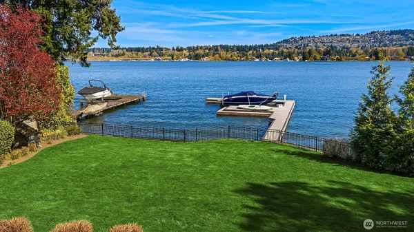 a view of a house with a yard and lake view
