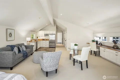 a living room with furniture and kitchen view