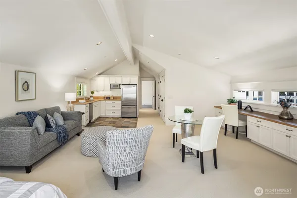 a living room with furniture and kitchen view