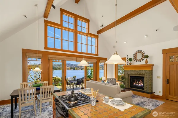 a living room with furniture a fireplace and a floor to ceiling window