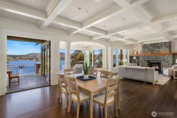 a dining room with furniture wooden floor and a floor to ceiling window