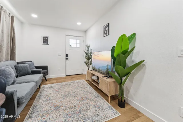 a living room with furniture rug and wooden floor