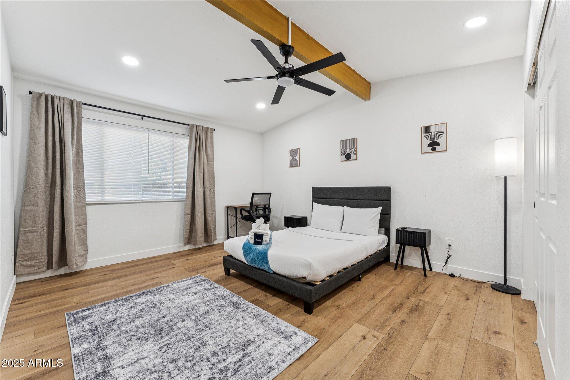 1548 North Upland Circle, Unit B Mesa, AZ 85201 - Photo 11 of 18 a bedroom with a bed and wooden floor