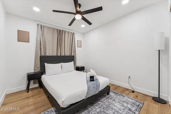 a bedroom with a bed and a chandelier