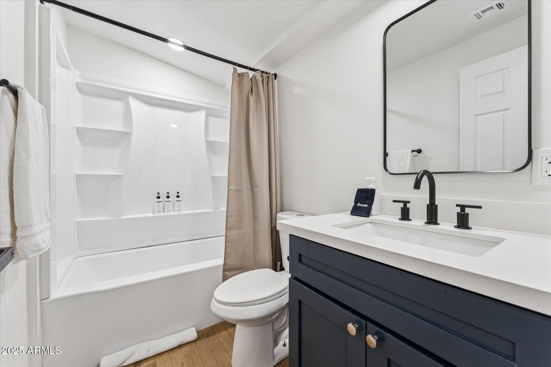 1548 North Upland Circle, Unit B Mesa, AZ 85201 - Photo 15 of 18 a bathroom with a sink a toilet and shower
