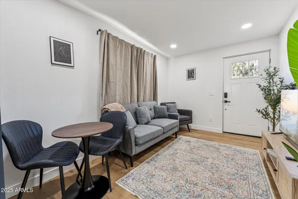 a living room with furniture and a potted plant