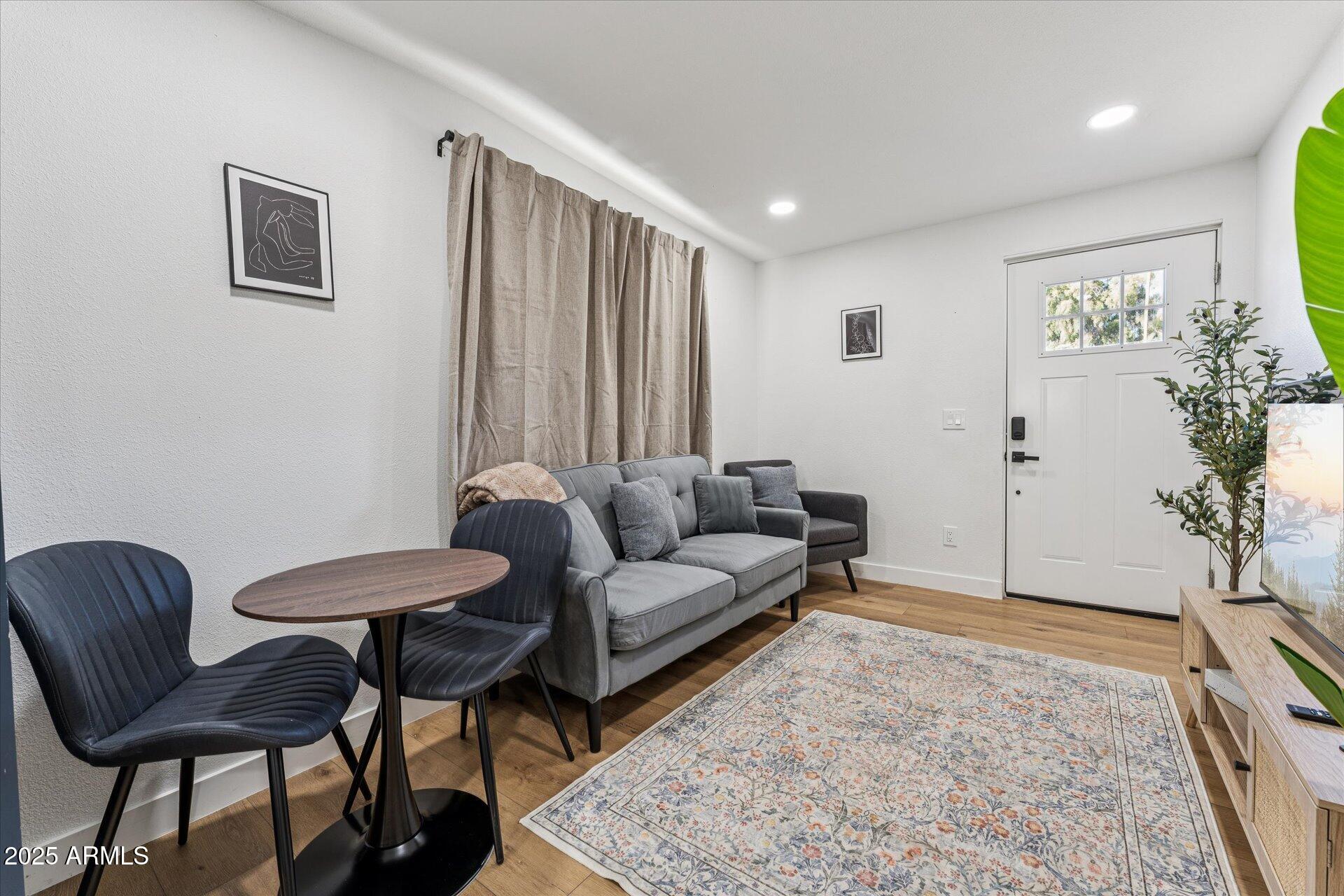 1548 North Upland Circle, Unit B Mesa, AZ 85201 - Photo 3 of 18 a living room with furniture and a potted plant