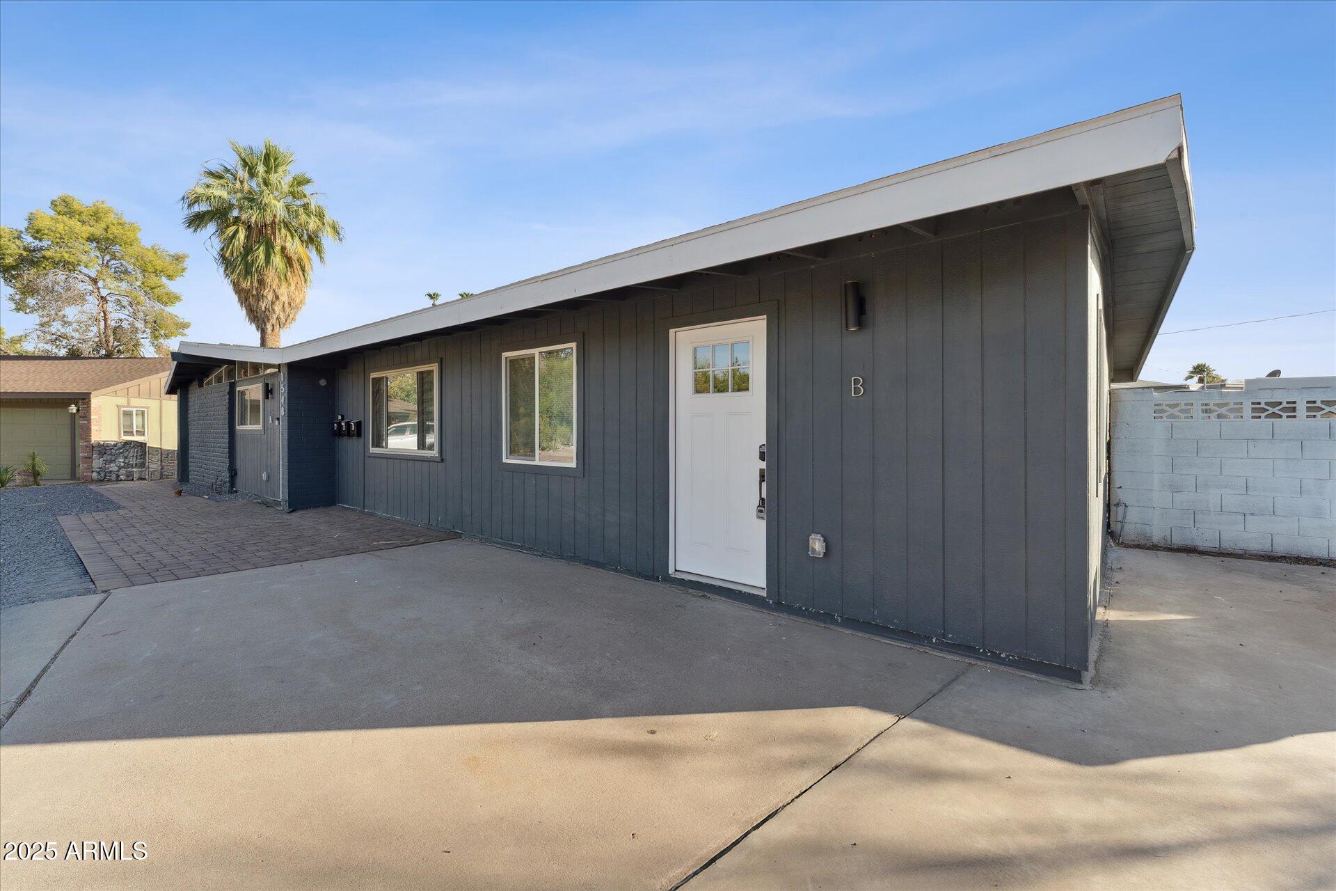 1548 North Upland Circle, Unit B Mesa, AZ 85201 - Photo 8 of 18 a front view of a house with a yard