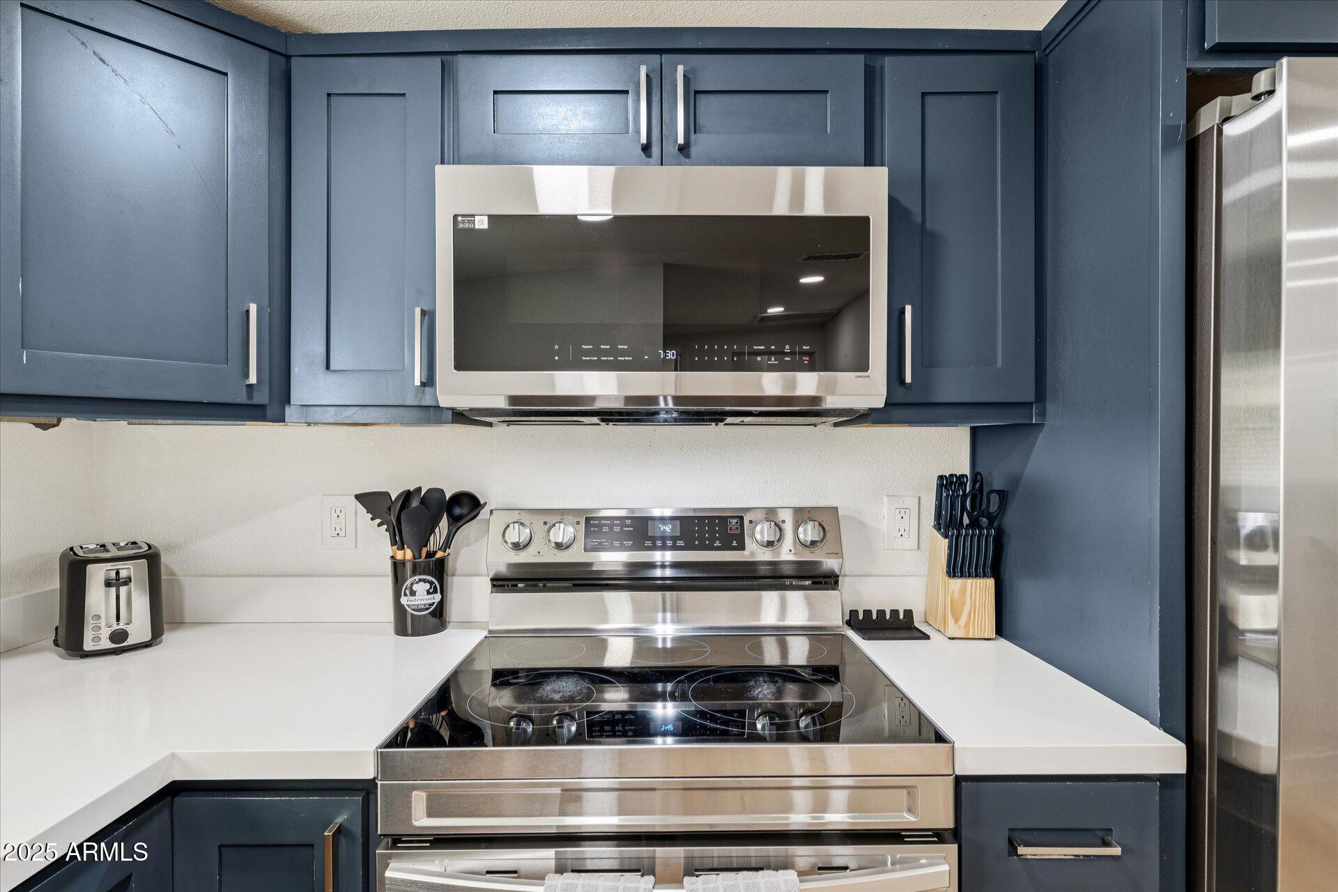 1548 North Upland Circle, Unit B Mesa, AZ 85201 - Photo 10 of 18 a kitchen with a stove and microwave