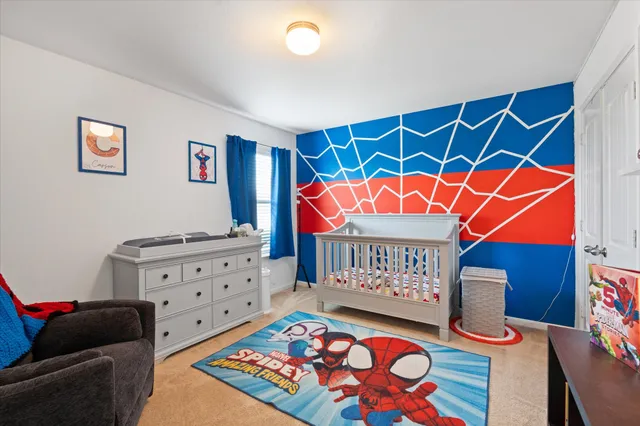 a room with furniture and baby crib