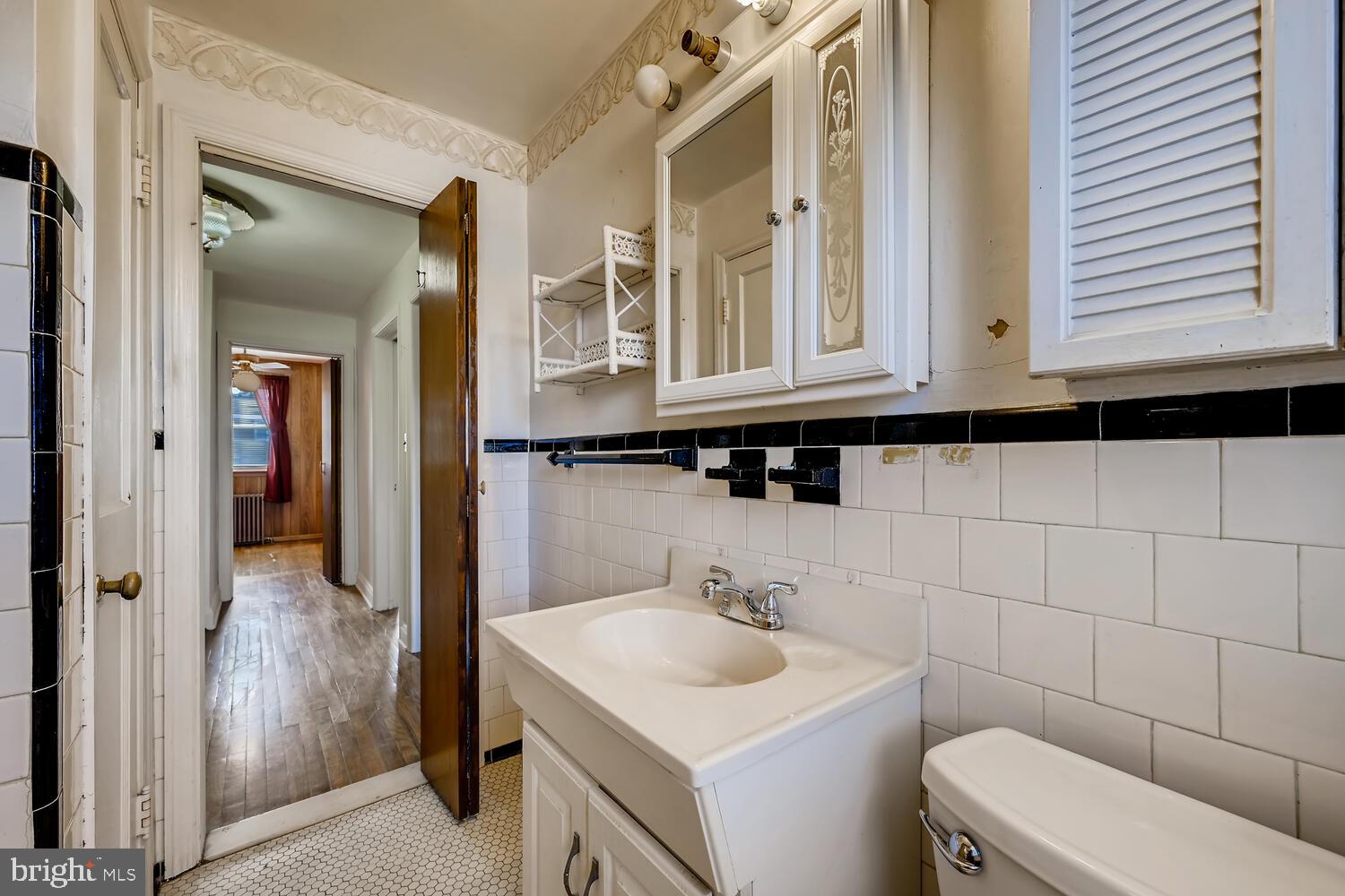 318 Arden Road West Baltimore, MD 21225 - Photo 19 of 32 a bathroom with a sink a toilet and a mirror