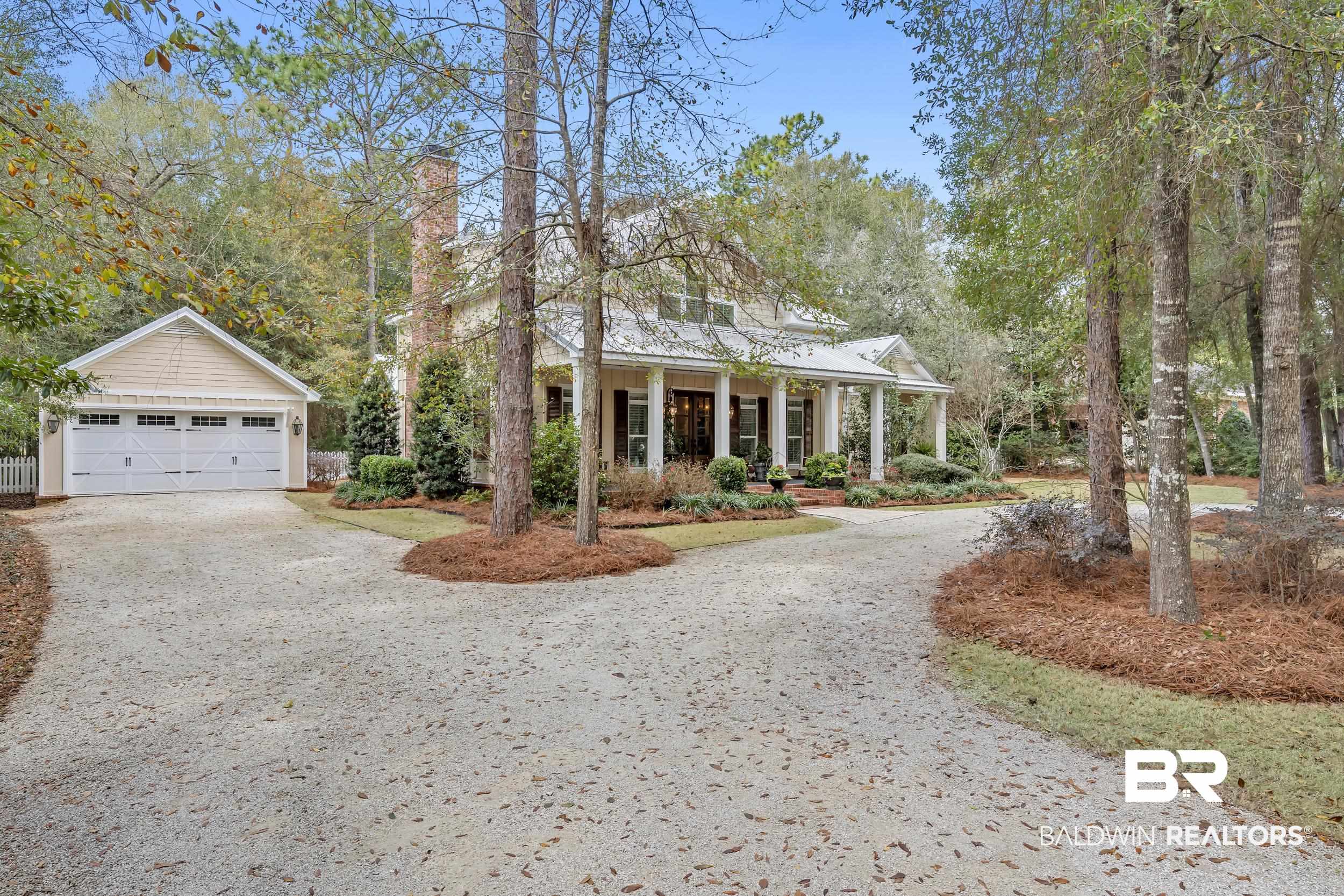 12161 Jessamine Street Magnolia Springs, AL 36555 - Photo 61 of 70 View of front of house featuring covered porch, a chimney, a detached garage, an outbuilding, and driveway