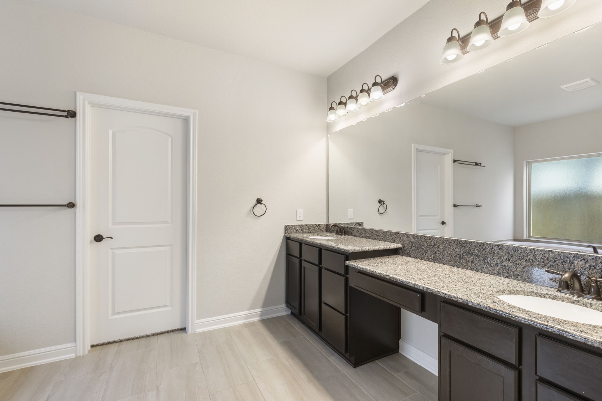 2819 Bradbury Hills Road Spring, TX 77373 - Photo 31 of 50 Experience luxury in this primary bathroom featuring elegant granite countertops, dual sinks, and stylish modern lighting, creating a serene and sophisticated retreat.