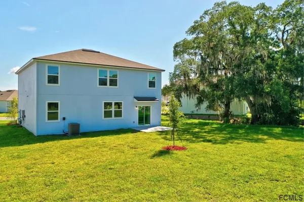 an aerial view of a house with a swimming pool yard and outdoor seating