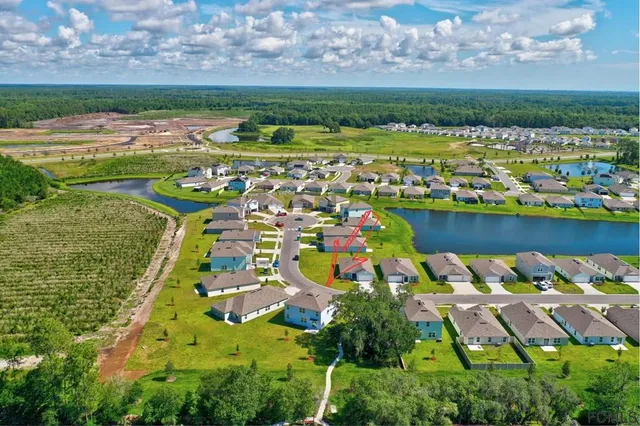 an aerial view of residential house with outdoor space and swimming pool
