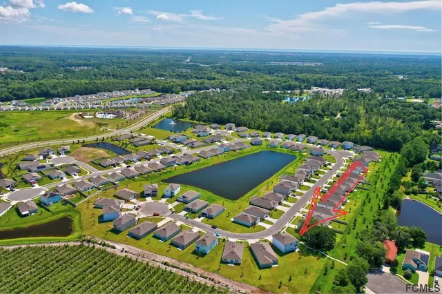 an aerial view of a house with garden space and street view