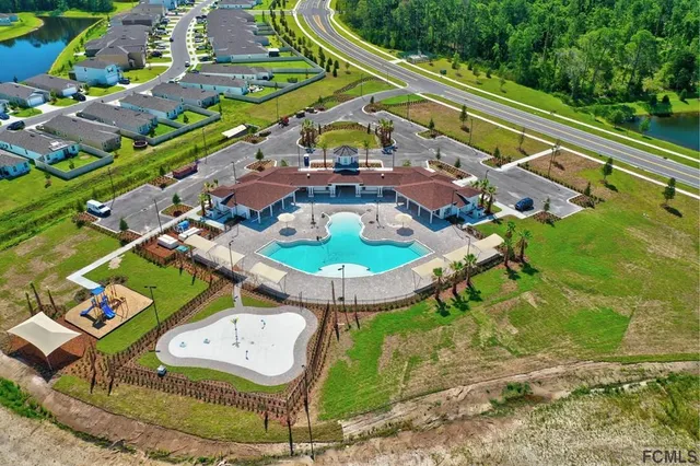 an aerial view of a house with garden space and street view