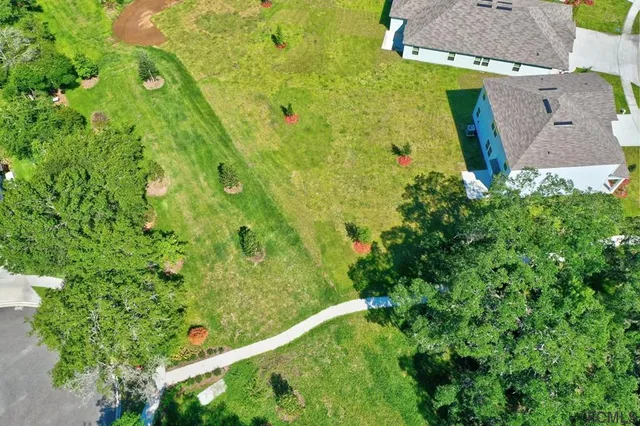 a large white kitchen with wooden floor and stainless steel appliances