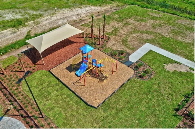 a view of kitchen with kitchen island white cabinets and refrigerator