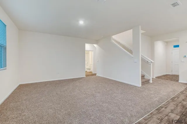 a view of an empty room and entryway