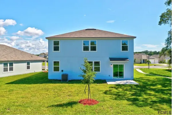 an aerial view of a house with a garden