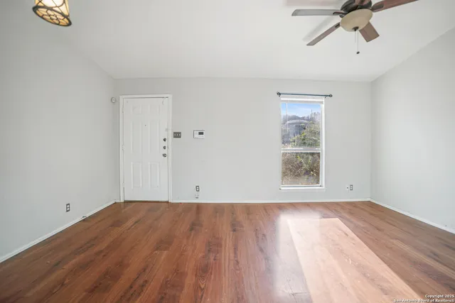 a view of room with hardwood floor and window