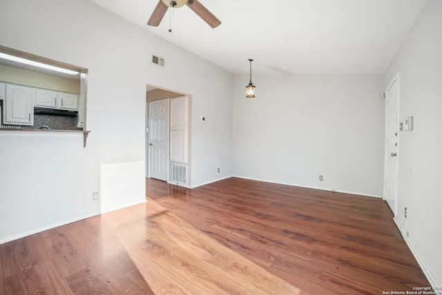 a view of empty room with wooden floor