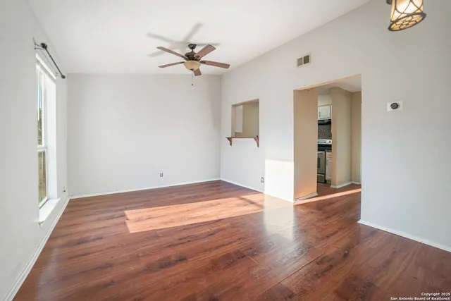 a view of an empty room and wooden floor