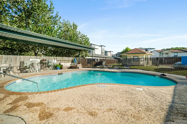 a view of a swimming pool and a yard