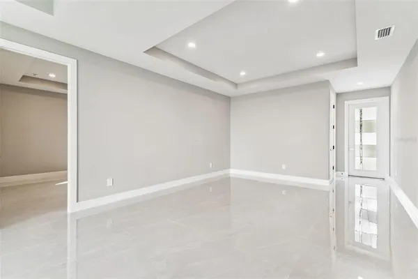 a large kitchen with stainless steel appliances granite countertop a stove a sink and a microwave