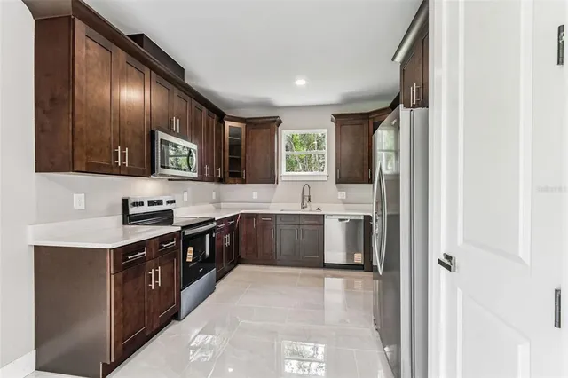 a kitchen with stainless steel appliances granite countertop a stove and a microwave