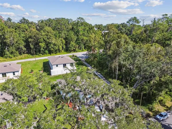 an aerial view of a house with a garden and a yard