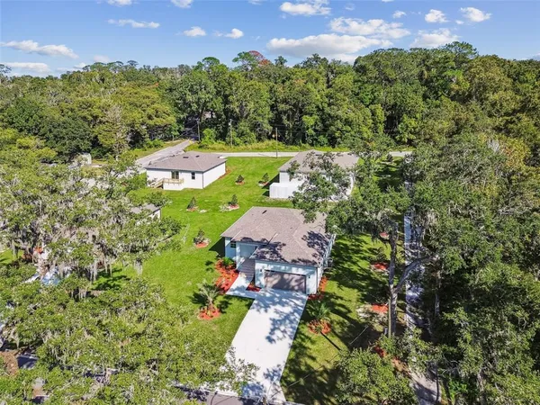 an aerial view of a house with swimming pool garden and patio