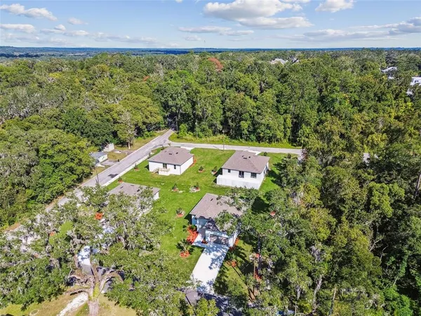 a aerial view of a house with swimming pool and a yard