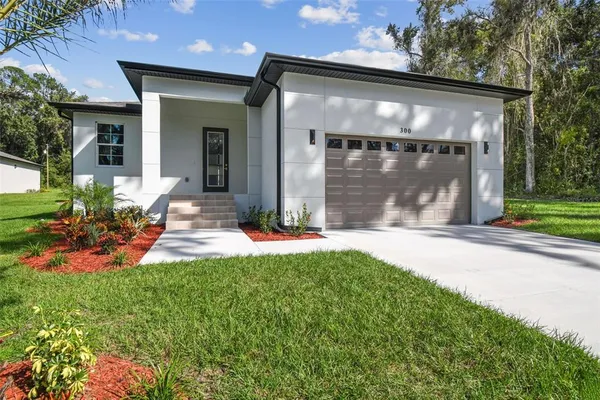 a front view of a house with a yard and porch