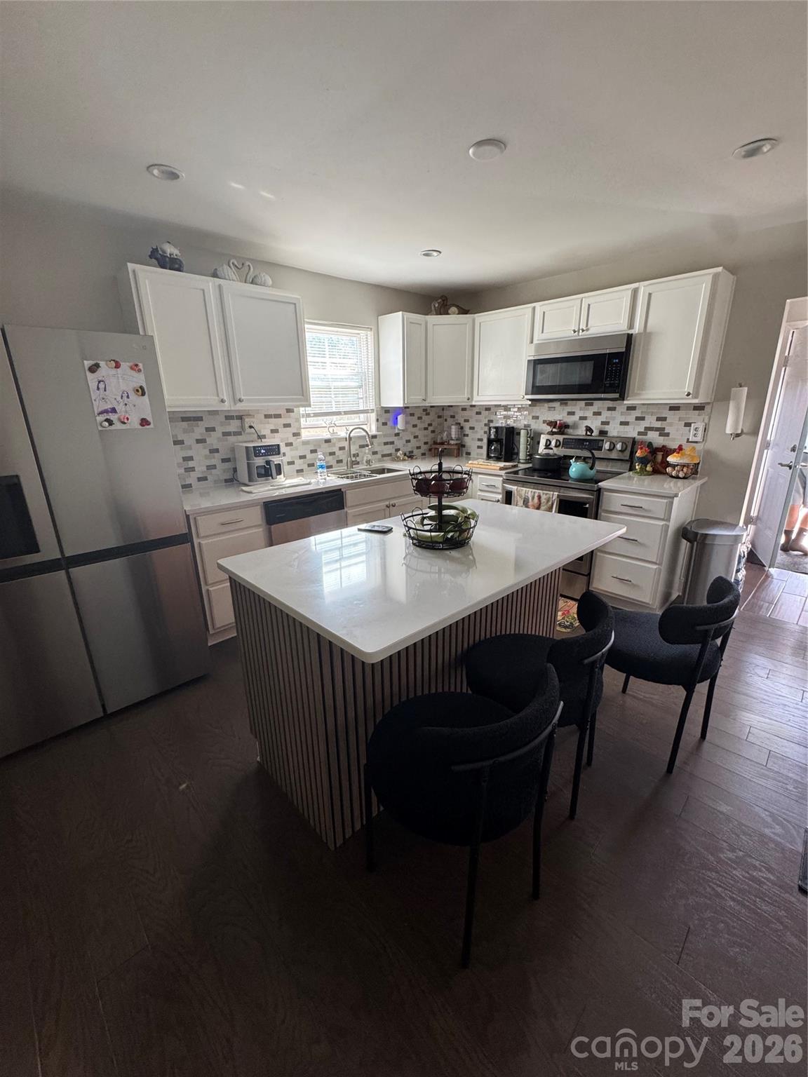 1319 Rollings Roost Road Lancaster, SC 29720 - Photo 3 of 29 a kitchen with a dining table chairs and a refrigerator