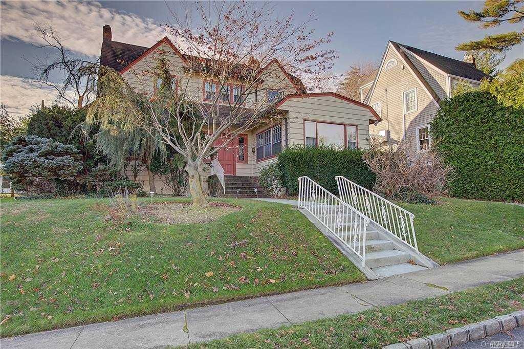 8 Windsor Road Great Neck, NY 11021 - Photo 1 of 1 a front view of a house with garden