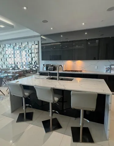 a kitchen with a table chairs sink and cabinets