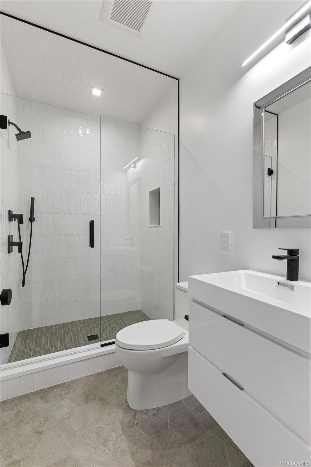 42 Mamaroneck Road Scarsdale, NY 10583 - Photo 44 of 47 A modern full bath adjacent to the guest suite completes the lower level, offering privacy and comfort for family and visitors alike.