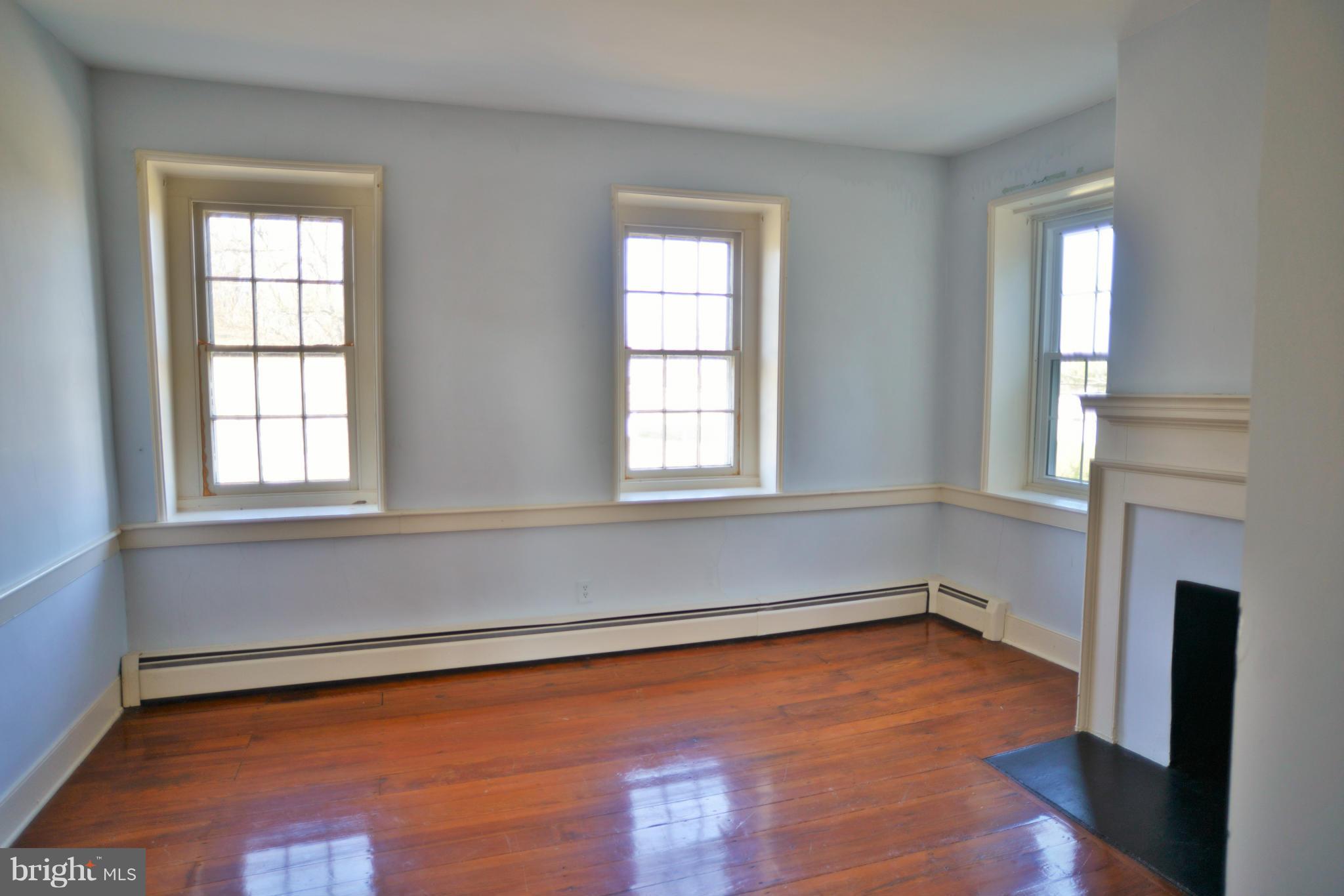 2203 Marker Road Middletown, MD 21769 - Photo 15 of 21 an empty room with a fireplace and windows
