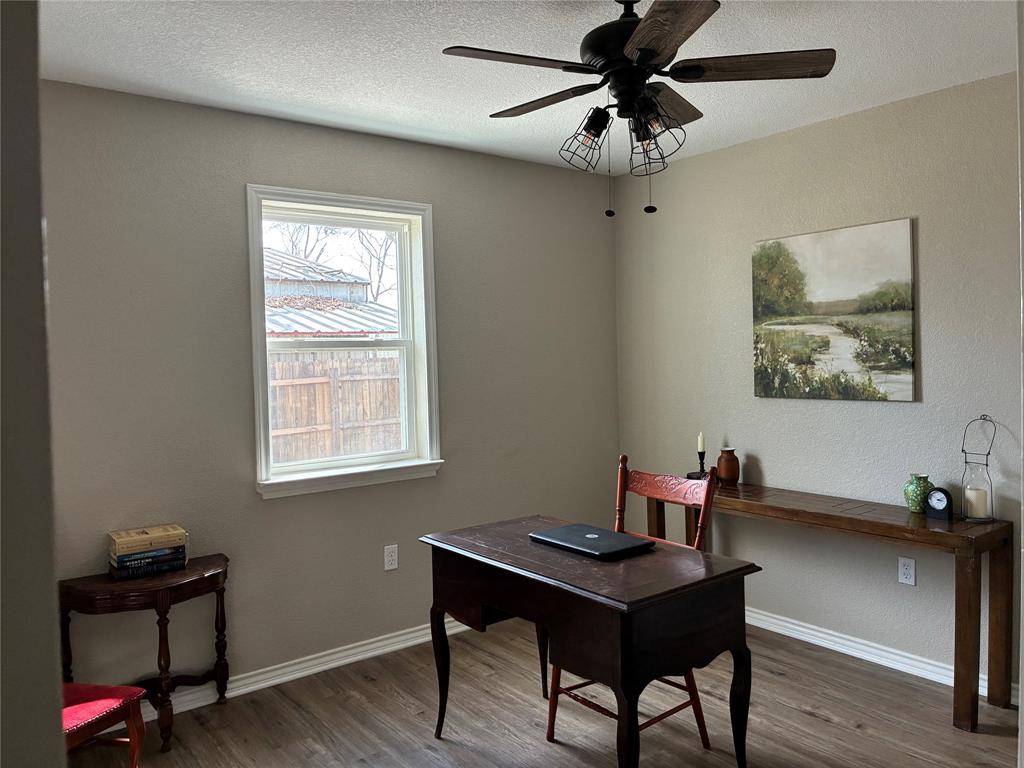 5066 East Highway 199 Springtown, TX 76082 - Photo 12 of 15 Home office featuring vinyl floors, ceiling fan, a textured wall, and a textured ceiling