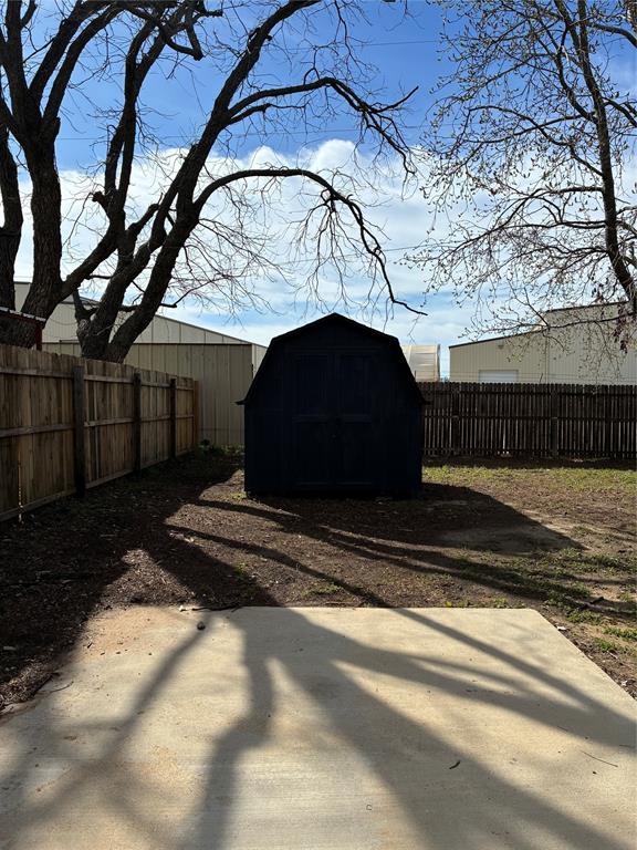 5066 East Highway 199 Springtown, TX 76082 - Photo 4 of 15 Fenced backyard with a storage unit