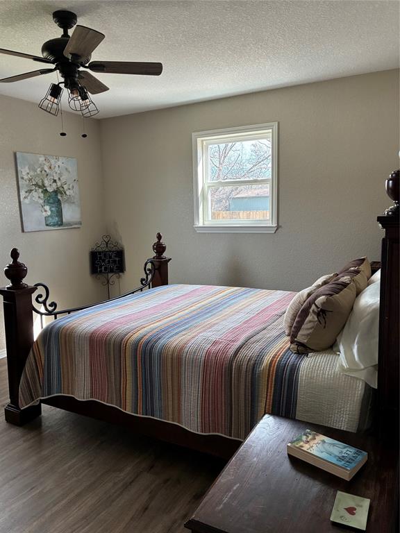 5066 East Highway 199 Springtown, TX 76082 - Photo 10 of 15 Bedroom with vinyl flooring, a textured ceiling, and a ceiling fan
