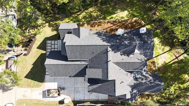 an aerial view of a house with a yard