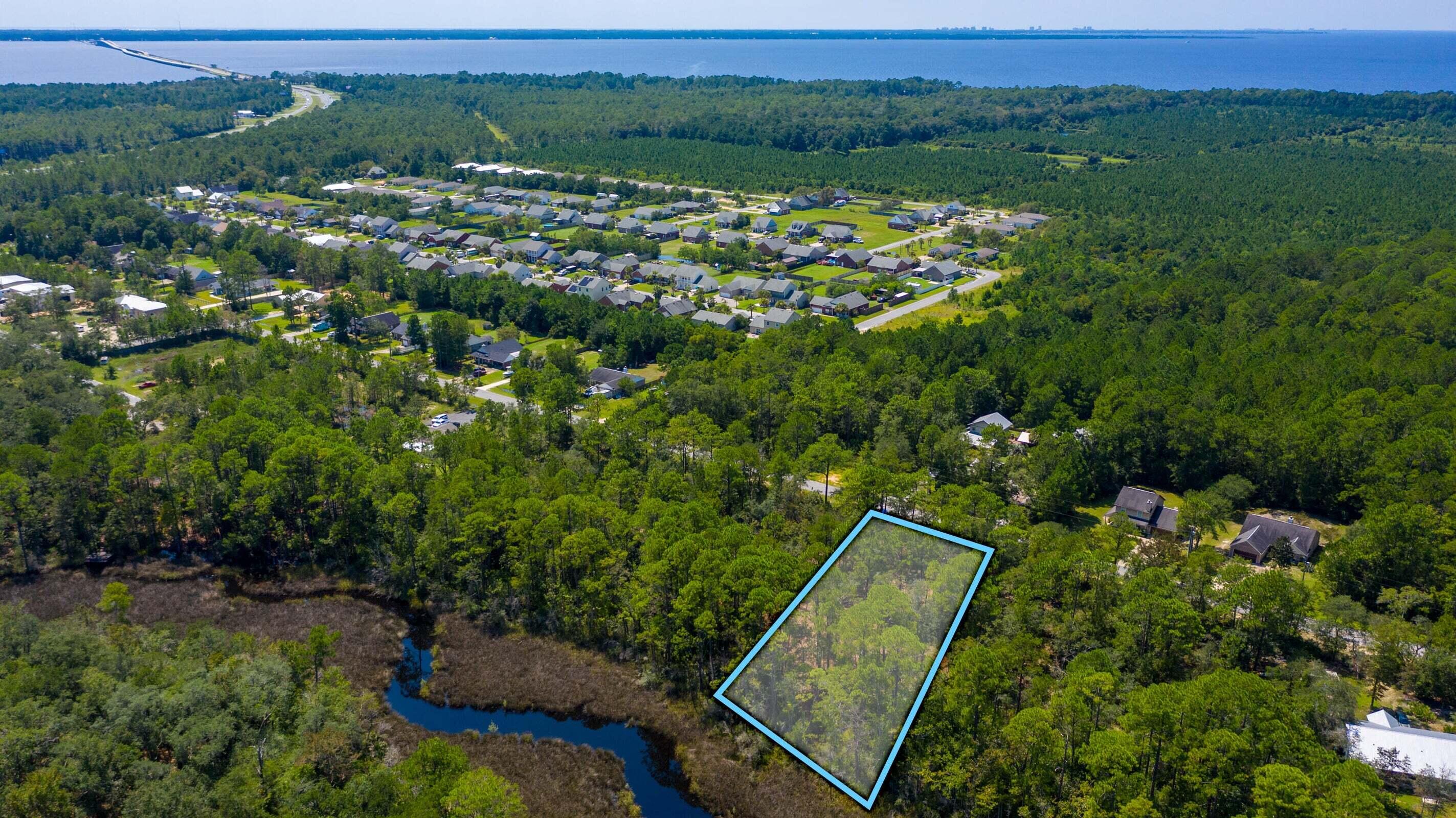 Lot 6 Bay Grove Road Freeport, FL 32439 - Photo 4 of 14 an aerial view of a residential houses with outdoor space and trees