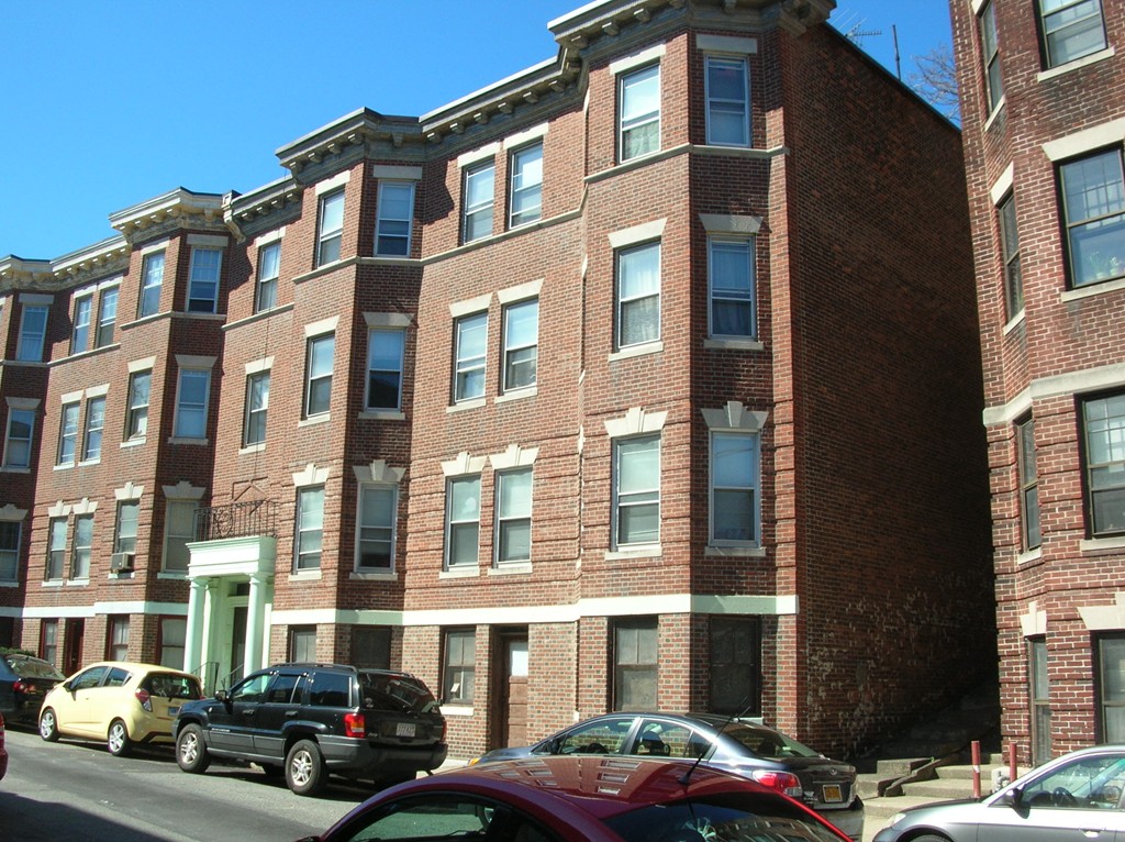 a car parked in front of a brick building