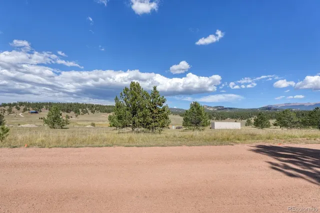 a view of a lake with sunset in background