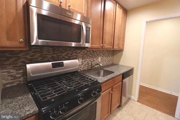 a kitchen with a stove and a microwave